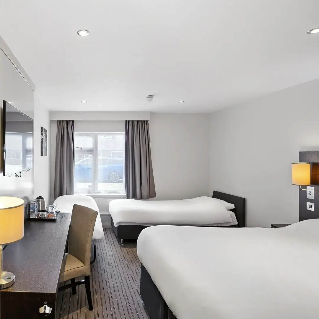 A modern hotel room with two twin beds